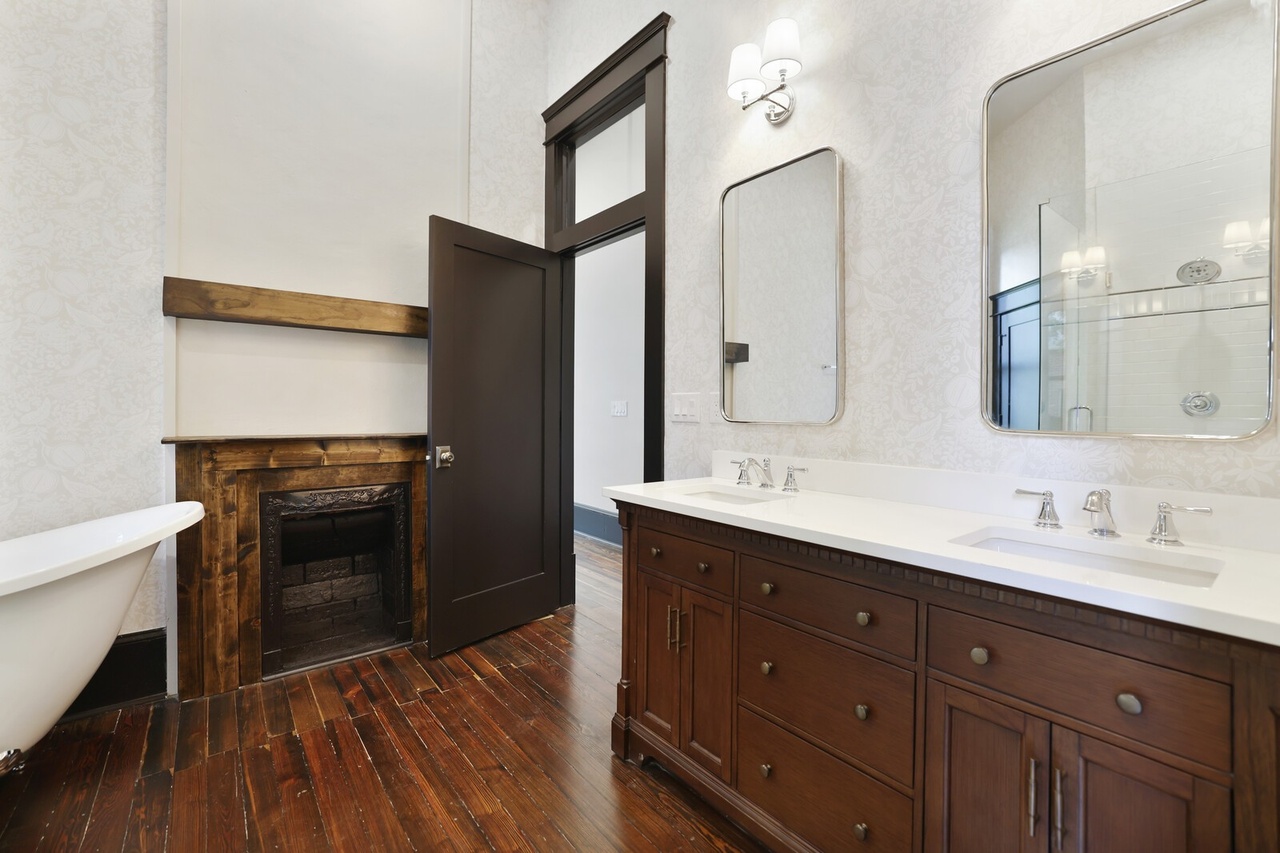 Master bathroom with clawfoot tub and fireplace